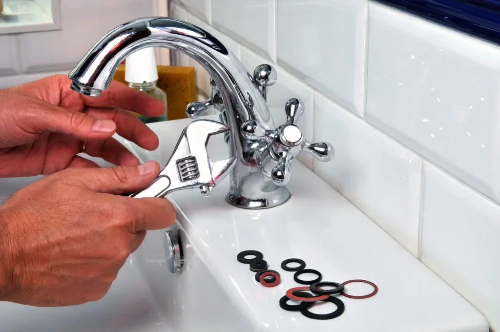 Plumber performing maintenance on a bathroom faucet in Cocoa
