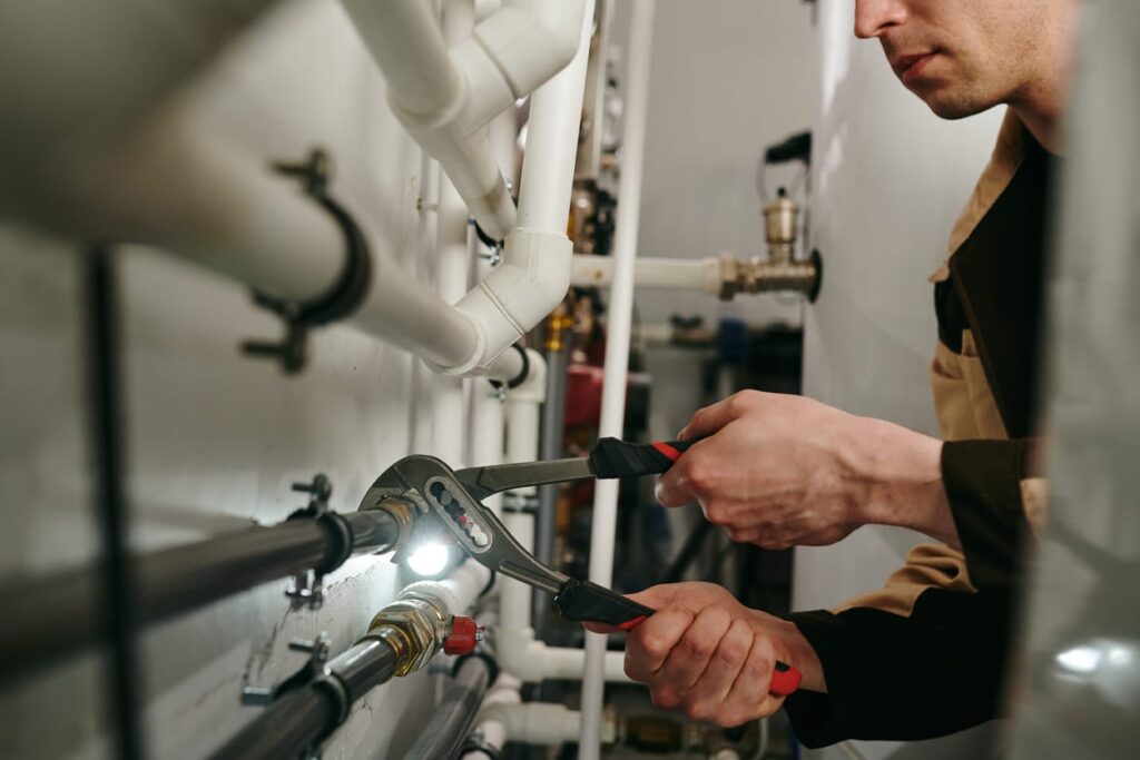 Plumbers maintaining commercial plumbing pipes in Cocoa