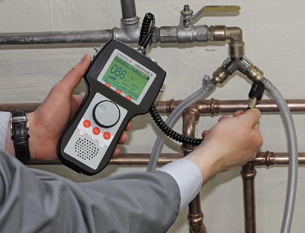 Plumber testing pipes with electronic leak detection equipment in Cocoa