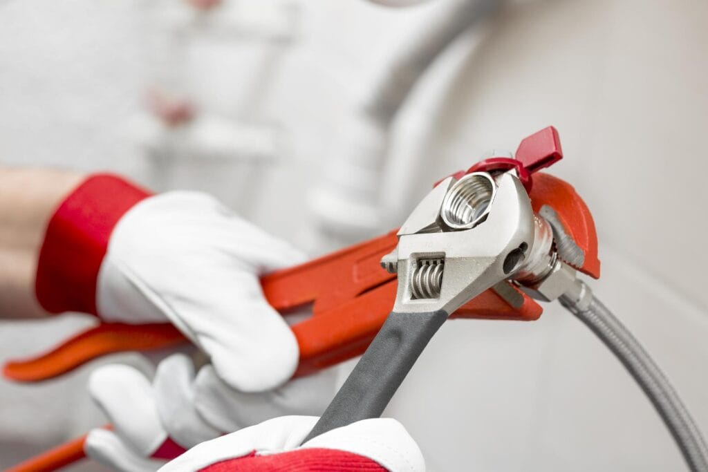 Plumber holding pipe wrenches for an emergency repair in Cocoa