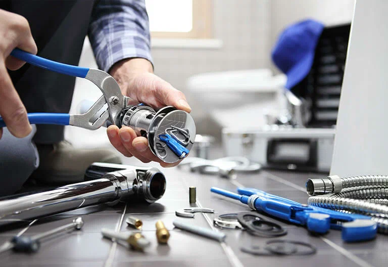 Technician repairing a plumbing fixture with professional tools in Cocoa
