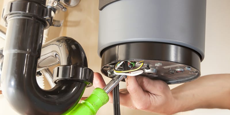 Technician repairing the heating element of a water heater in Cocoa