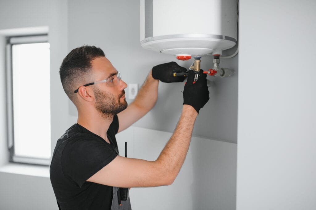 Technician performing water heater maintenance in Cocoa