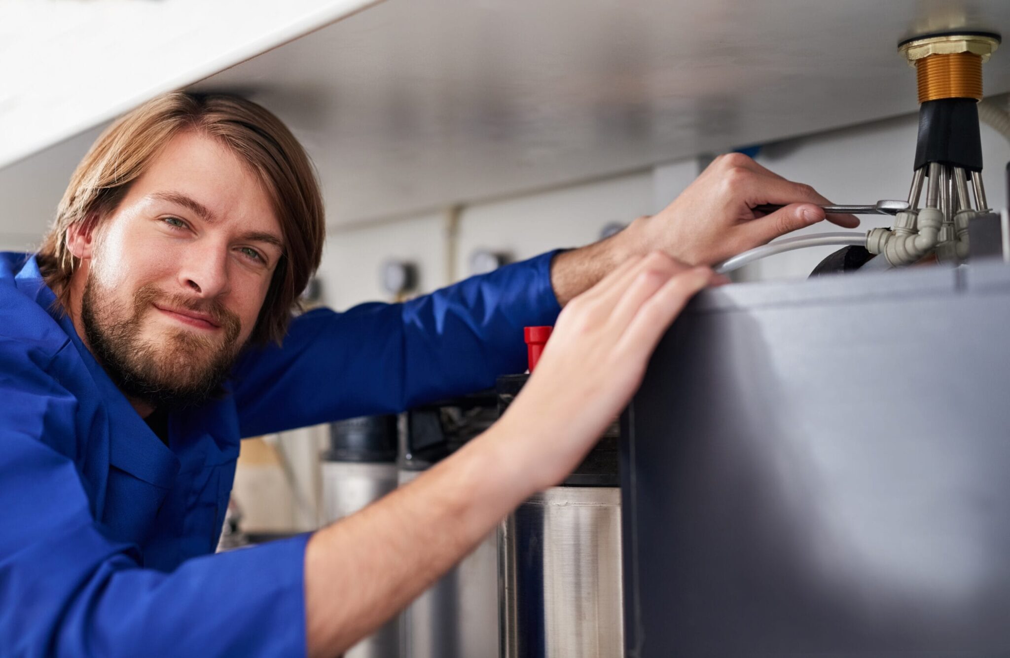Technician servicing a residential water heater tank in Cocoa