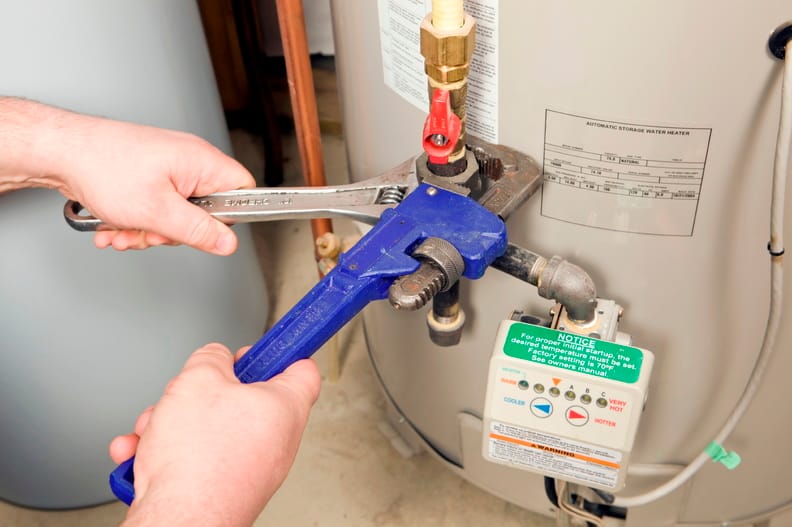 Plumber repairing a water heater valve in Cocoa